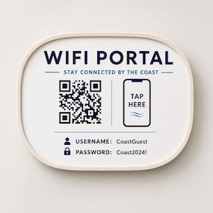 May include: A white, rectangular sign with rounded corners displays the words "WIFI PORTAL" in navy blue. Below, it reads "STAY CONNECTED BY THE COAST." A QR code and a phone icon with "TAP HERE" are featured. The sign also includes the username and password.