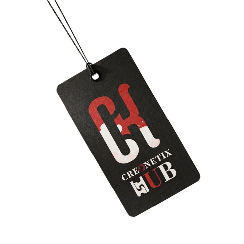 May include: A rectangular black hang tag with rounded corners, featuring a large stylised red and white logo at the top. Below the logo, the text CREONETIX HUB is printed in white and red, with a thin black string attached through a metal eyelet.