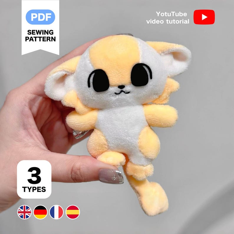 K&ouml;nnte beinhalten: Ein Pl&uuml;schtier in Form eines Zeichentricktiers, haupts&auml;chlich gelb und wei&szlig;, mit gro&szlig;en schwarzen Augen. Das Spielzeug wird in einer Hand gehalten. Der Text auf dem Bild lautet "PDF SEWING PATTERN", "YotuTube video tutorial" und "3 TYPES".