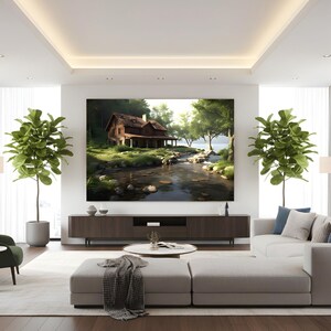 Op de afbeelding: Een moderne woonkamer met een groot landschapsschilderij van een hut aan een rivier. De kamer heeft een witte hoekbank, een groene fauteuil en twee hoge planten in potten. Een salontafel en een donkerhouten entertainmentcenter maken de ruimte compleet.