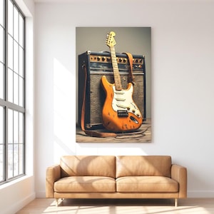 May include: An orange electric guitar with a white pickguard and a brown leather strap leans against a black amplifier. The guitar has a distressed finish. The image is set in a room with a tan leather sofa and a large window.
