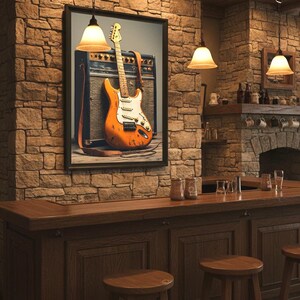 May include: A framed print of an orange electric guitar with a white pickguard and a brown strap, leaning against a vintage amplifier. The image is displayed in a rustic bar setting with stone walls and wooden furniture.