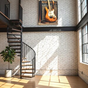 May include: An orange electric guitar with a white pickguard leans against a vintage amplifier, mounted on a white brick wall. The room features a spiral staircase, hardwood floors, and large windows, creating a modern, industrial aesthetic.