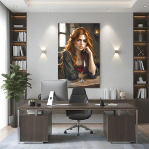 May include: An office interior with a painting of a woman with red hair and a glass of red wine. The room includes a dark wood desk, a black office chair, and bookshelves filled with books. A large plant sits in the corner. The room has a modern design.
