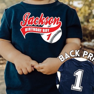 Navy shirt with a baseball design featuring Childs name number for the age as well text Birthday Boy in the swoosh under the name, big number 1 printed on the back of the shirt. Perfect for 1st birthday baseball theme party