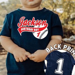 Baby boy 1st birthday baseball shirt, navy shirt with name in red script font and baseball with a number 1 printed on the back of the shirt