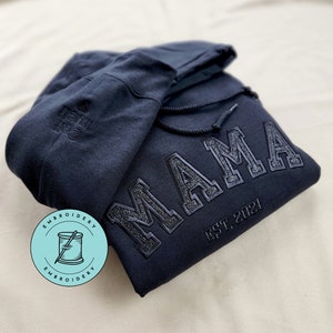 Custom Mama Sweatshirt Embroidered with kids names on sleeve. This Black Hoodie features black thread with black glitter.