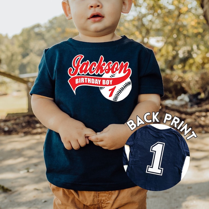 Baby boy 1st birthday baseball shirt, navy shirt with name in red script font and baseball with a number 1 printed on the back of the shirt