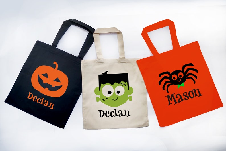 Personalized treat or trick Halloween bags for kids. Halloween tote bag featuring pumpkin, green monster and spider with kids name available on black, natural or orange tote