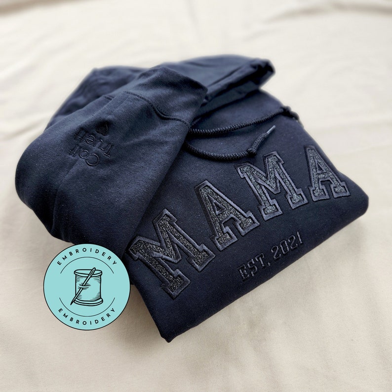Custom Mama Sweatshirt Embroidered with kids names on sleeve. This Black Hoodie features black thread with black glitter.