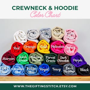 May include: A color chart for crewneck and hoodie apparel, featuring a variety of rolled-up fabric samples. Colors include white, red, orange, gold, green, blue, and more. The text "CREWNECK & HOODIE Color Chart" is at the top.