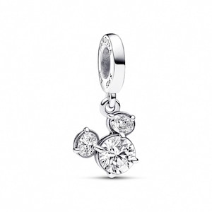 A silver-toned charm bracelet with a pendant featuring three round diamonds.