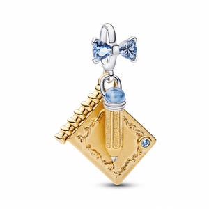 May include: A charm with a silver bow adorned with blue gemstones, a gold notebook, and a pencil with a blue gemstone eraser. The notebook and pencil are gold-toned with detailed designs. A small blue gemstone is set on the notebook.