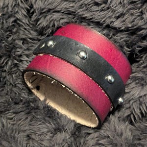 May include: A set of three ceramic mugs with a speckled, matte finish. The mugs are in shades of cream, light gray, and dark gray. Each mug has a simple, minimalist design, perfect for coffee or tea.