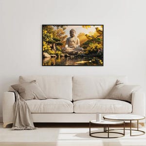 May include: A framed artwork depicting a serene scene with a seated Buddha statue near a pond. The artwork features a black frame, with yellow and green foliage, and two yellow birds. The artwork is hanging above a beige sofa.