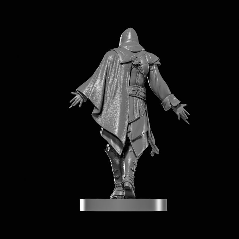 May include: A gray figurine of a person in a hooded cloak, cape, and boots, viewed from the back. The figure has outstretched arms and is standing on a rectangular base against a black background. The clothing has detailed textures.