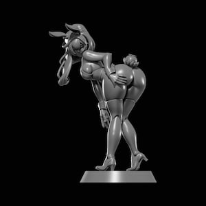 May include: A grayscale 3D-printed figurine of a person in a bunny costume, bent over with one hand on their rear. The figure is wearing a bunny ear headpiece, a leotard, and high heels. The figurine is standing on a rectangular base.