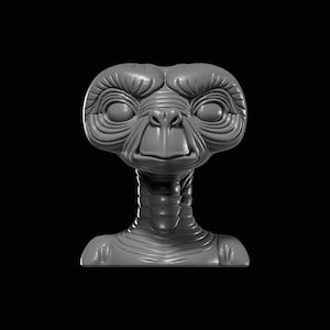 May include: A grey sculpture of the E.T. alien character. The figure has large eyes, a long neck, and detailed facial features. The sculpture is set against a black background.