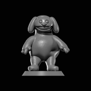 May include: A gray, textured figurine of a smiling cartoon character with large ears and a round body. The figure stands on a rectangular base against a black background. The character has small arms and feet.