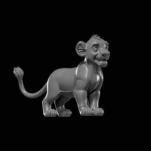 May include: A gray 3D-printed lion cub figurine, standing with a slight smile. The cub has detailed features, including a fluffy tail and upright ears. The figurine is set against a black background.