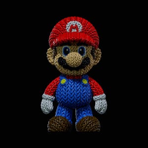 May include: A knitted Mario figurine, with a red hat and white 'M' emblem, blue dungarees, and a brown moustache. The figure has blue eyes, white gloves, and brown shoes. Set against a black background.