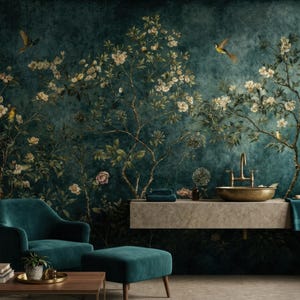 May include: A teal armchair and ottoman sit in front of a wall mural depicting a floral and bird design. The mural features a dark teal background with flowering branches and birds. A gold-toned sink and faucet are also visible.