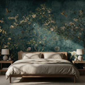 May include: A bedroom with a wooden bed frame and a beige comforter. The headboard is against a teal wall mural depicting flowering branches and birds. Two matching nightstands with lamps flank the bed. The room is illuminated by natural light.