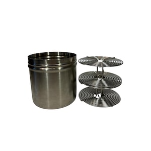 May include: A stainless steel film developing kit, including a cylindrical container and a three-tiered film reel holder. The kit is designed for processing photographic film. The items are made of shiny, silver-colored metal.