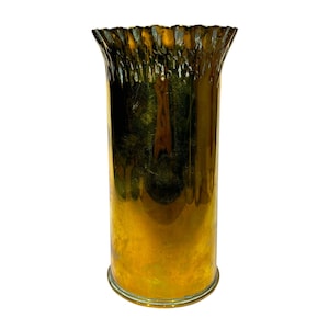 May include: A cylindrical glass vase with a metallic gold finish. The vase features a smooth, reflective body that transitions into a textured, ruffled rim at the top. The glass has a warm, amber-toned sheen throughout its entire surface.