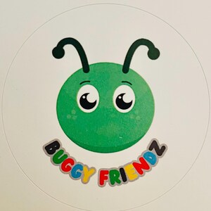 May include: A circular sticker with a cartoon green bug face, large eyes, and curved antennae. The text "Buggy Friendz" is written in colourful letters below the bug's face.