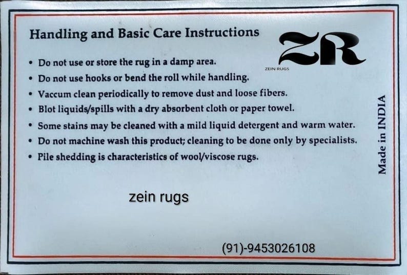 May include: A white card with black text detailing rug care instructions. The card includes advice on cleaning, storage, and maintenance. The brand name "zein rugs" is displayed, along with a logo and contact information.