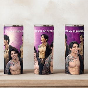 May include: Three cylindrical tumblers featuring a purple galaxy background and the text "YOU ARE THE CAUSE OF MY EUPHORIA." Each tumbler displays a photographic print of a person with dark hair, tattoos on their arms, and an open dark shirt.