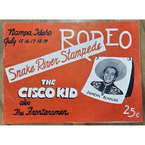 Puede incluir: Un cartel de rodeo vintage naranja con el texto "RODEO Snake River Stampede" y "The Cisco Kid". Incluye un retrato de Duncan Renaldo y el texto "Nampa, Idaho July 15-16-17-18-19".