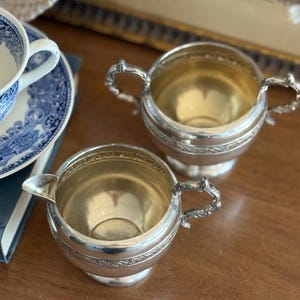 May include: A set of three ceramic mugs with a speckled, matte finish in cream, light grey, and dark grey. Each mug has a simple, minimalist design, suitable for coffee or tea.