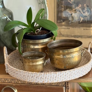 May include: A distressed wooden sign with the words "Welcome to our home" in white. The sign has a rustic finish, ideal for a porch or hallway, and a simple, welcoming design.