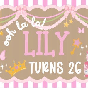 May include: A birthday banner with a brown background, pink and white striped border, and scalloped edges. The banner says "ooh la la!" and "LILY TURNS 26" in pink and white. It features a cake, butterflies, stars, a crown, and a magic wand.