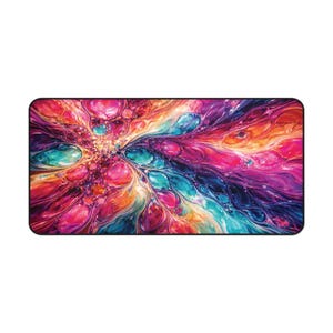 May include: A rectangular mousepad with a vibrant, abstract design. The artwork features a swirling pattern of colors, including pink, purple, teal, and orange. The edges of the mousepad are black, providing a clean border for the colorful design.