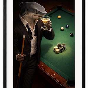 May include: A framed print featuring a shark-headed figure in a suit, holding a cocktail and a pool cue. The shark is at a pool table with balls and chips. The image has a dark, moody aesthetic.