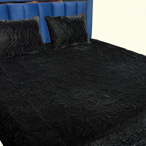 Black velvet hand stitched quilt with matching pillow covers on bed, luxury handmade bedding set with soft textured velvet fabric