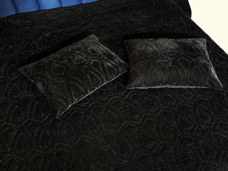 Black velvet hand stitched quilt with matching pillow covers on bed, luxury handmade bedding set with soft textured velvet fabric