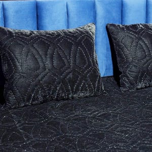 Black velvet hand stitched quilt with matching pillow covers on bed, luxury handmade bedding set with soft textured velvet fabric