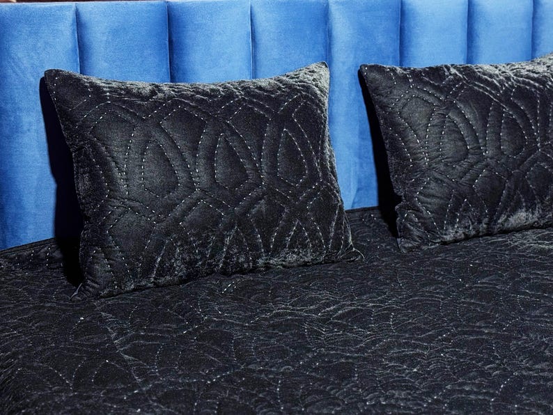 Black velvet hand stitched quilt with matching pillow covers on bed, luxury handmade bedding set with soft textured velvet fabric