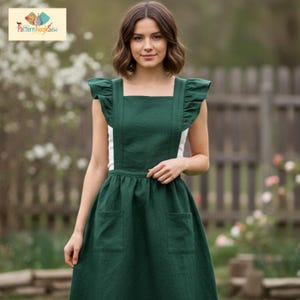 May include: A dark green apron dress with white accents and two front pockets. The dress features ruffled sleeves and straps. The image includes the text "Pattern Nook Sew" in the upper left corner.