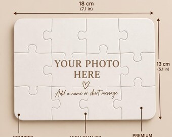 May include: A white 12-piece jigsaw puzzle with rounded corners, measuring 7.1 inches by 5.1 inches. The center features the text "YOUR PHOTO HERE" and "Add a name or short message" with a heart icon. The puzzle is made of cardboard.