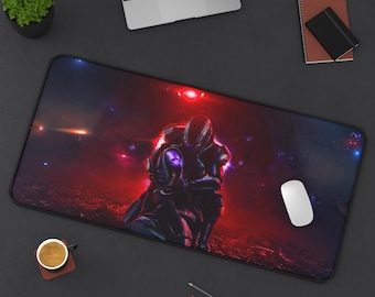 May include: A large, rectangular mouse pad featuring a science fiction scene with two figures in futuristic armor, set against a red and blue cosmic background. A white mouse, laptop, and other desk accessories are also visible.