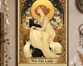 May include: A rectangular wall art print titled The Cat Lady featuring an illustration of a person in a flowing cream gown surrounded by black and white cats, set against a gold halo and intricate decorative border with floral motifs.