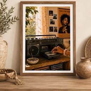 May include: A framed wall art print depicting a vintage black boombox on a wooden table. A hand inserts a CD into the player. In the background, a poster reads SOUL IN MY HEART, alongside several small polaroid photos on a wall near a window.
