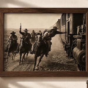 May include: A sepia-toned framed print depicting a group of riders on horseback chasing a steam train. The riders wear wide-brimmed hats and long coats, with one individual reaching toward the train car. The scene captures a dusty, outdoor setting.
