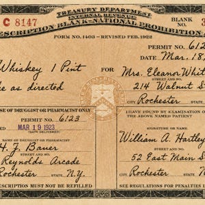 May include: A vintage tan Treasury Department Internal Revenue Prescription Blank for the National Prohibition Act, Form No. 1403, dated March 18, 1923. It features black printed text, a central seal, and handwritten details for Whiskey 1 Pint.