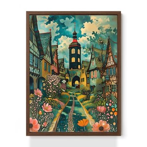 May include: A framed art print depicting a European village. The image shows colorful buildings, a tall tower, and a winding road with flowers. The sky is a mix of blue and white, creating a whimsical atmosphere.